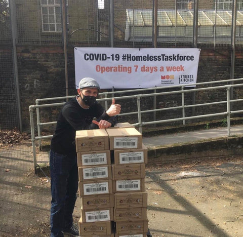 Homeless shelter volunteer receiving meals from Bol Foods