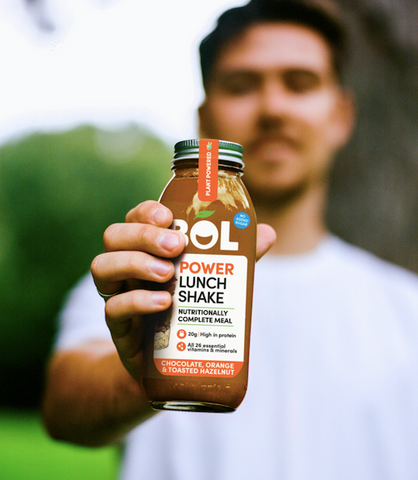 Man holding a chocolate and orange power shake