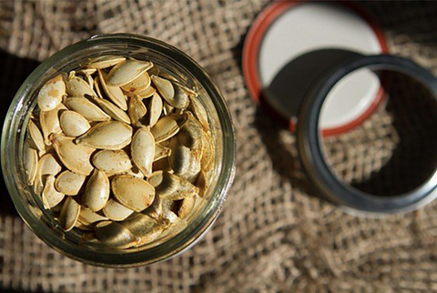 Roasted pumpkin seeds in glass jar