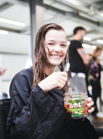 Model eating a BOL salad jar